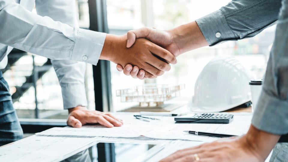 Engineer handshake meeting for architectural project and working