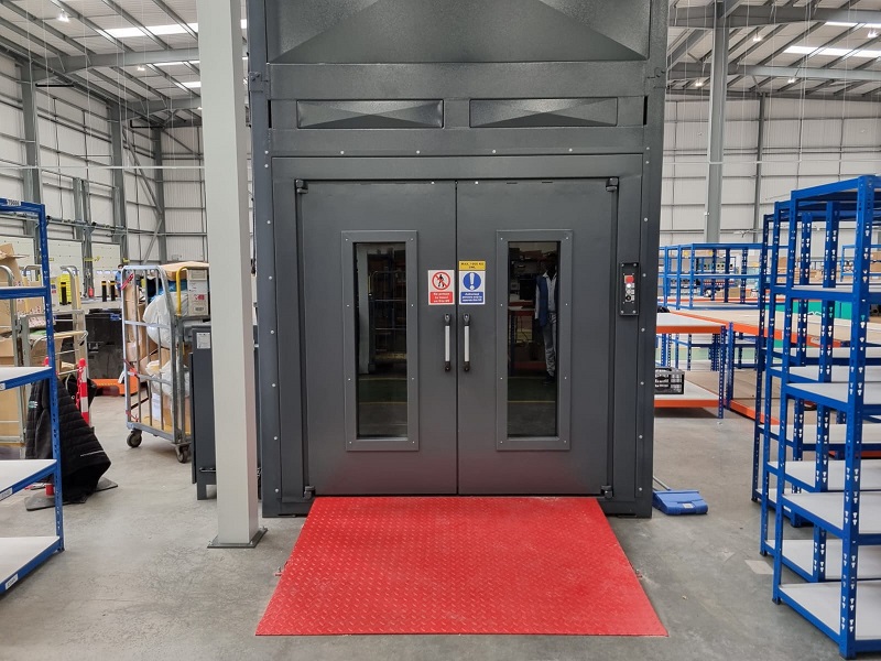 Mezzanine floor goods lift surrounded by storage shelves